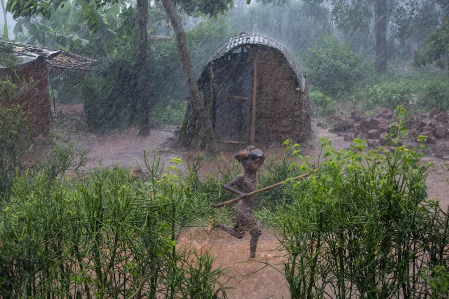 A child runs through a rainstorm in Kibande, northern Burundi. A child runs through a rainstorm in Kibande, northern Burundi.