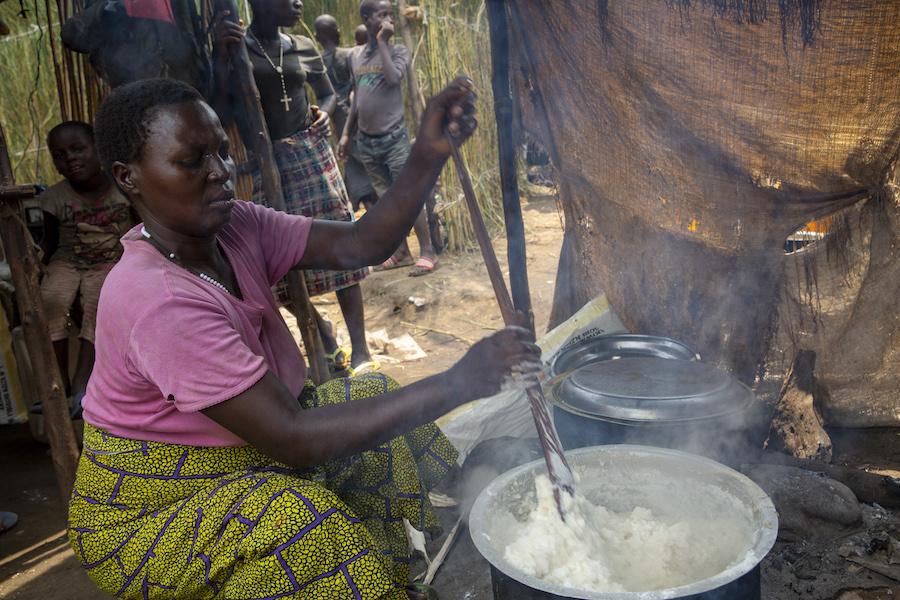 Odette Shurweryimana, a beneficiary of a micro-credit scheme funded by UNICEF and implemented by its partner Faith in Action, prepares a meal in her restaurant, located at a displacement camp in Gatumba, near Bujumbura in Burundi.