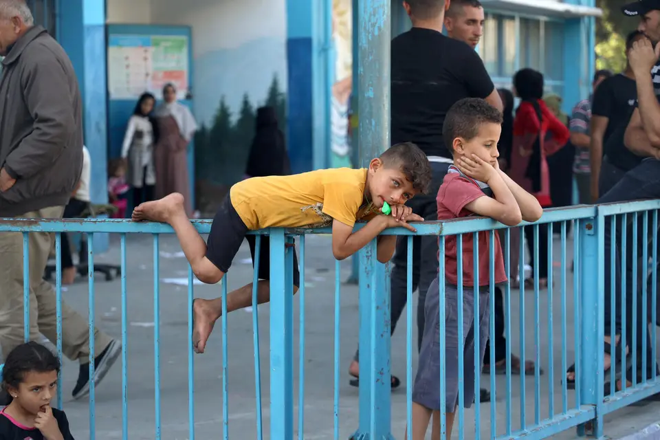 Boy Laying on Top of Fence