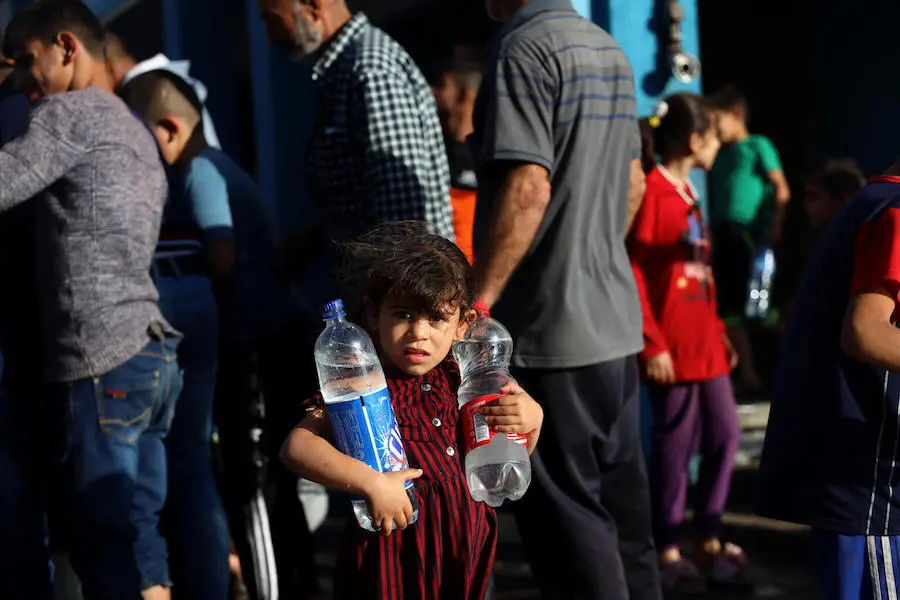 Young Girl Holding Water Bottles