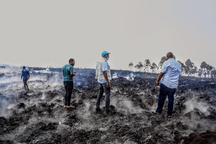 On May 23, 2021, UNICEF and Congolese Red Cross staff survey damaged caused by volcanic eruption in Goma, Democratic Republic of the Congo.