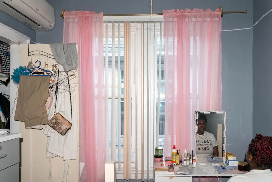 Girl Looking in Bedroom Mirror