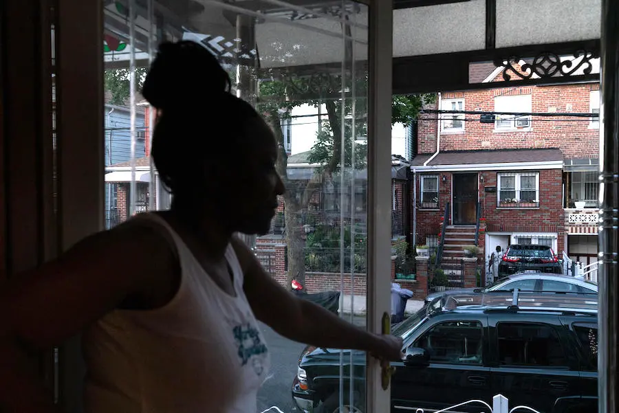 Woman Looking Out Open Door