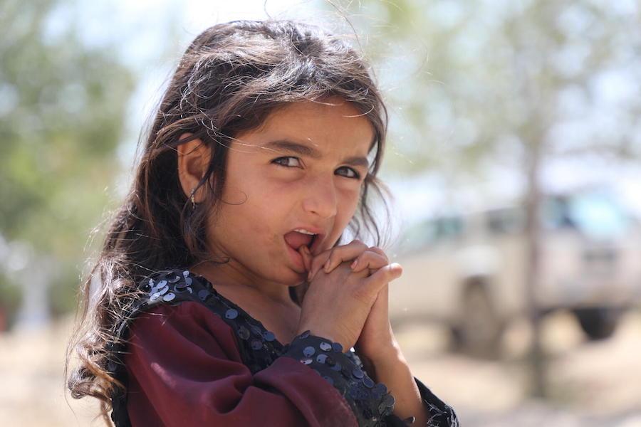 A girl stands at the Peer Mohammad Karkar high-school where more than 400 families from Kunduz, Sar-e Pol and Takhar provinces have taken shelter.