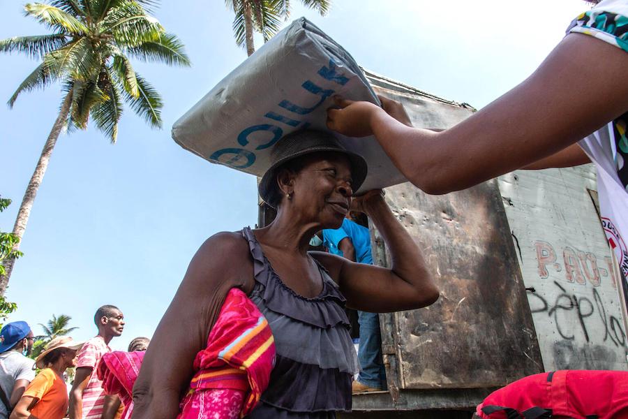 On August 18, 2021 in Valere, a village in Haiti's Sud Department, UNICEF workers distribute emergency supplies to families affected by Haiti's August 14, 2021 earthquake. 