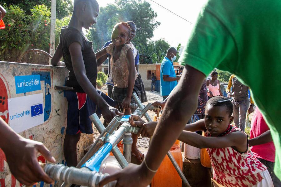 On August 18, 2021, in Marceline, near Haiti's Camp Perrin district, children and their families access clean and safe water at one of the four water stations supported by UNICEF in Les Cayes, Haiti. 