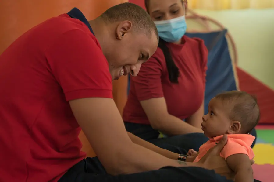 n Santo Domingo, Dominican Republic, a dad and mom take their baby son for a routine check-up that includes parent counseling on responsive caregiving and creative play through UNICEF's Care for Child Development program. n Santo Domingo, Dominican Republic, a dad and mom take their baby son for a routine check-up.