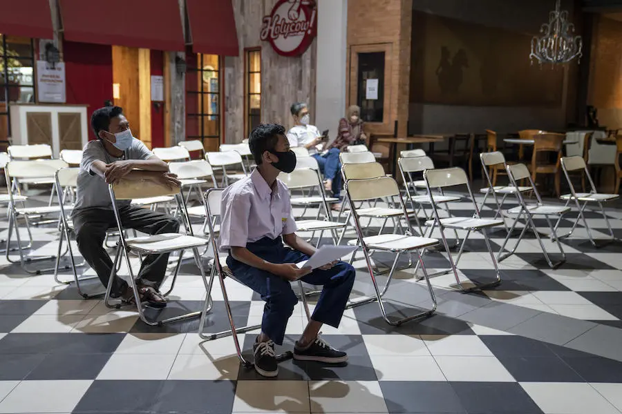 Fazil, 14, waits to receive his second dose of COVID-19 vaccine at the Cilandak Town Square Mall in South Jakarta, Indonesia, on August 24, 2021. Fazil, 14, waits to receive his second dose of COVID-19 vaccine at the Cilandak Town Square Mall in South Jakarta, Indonesia, on August 24, 2021.
