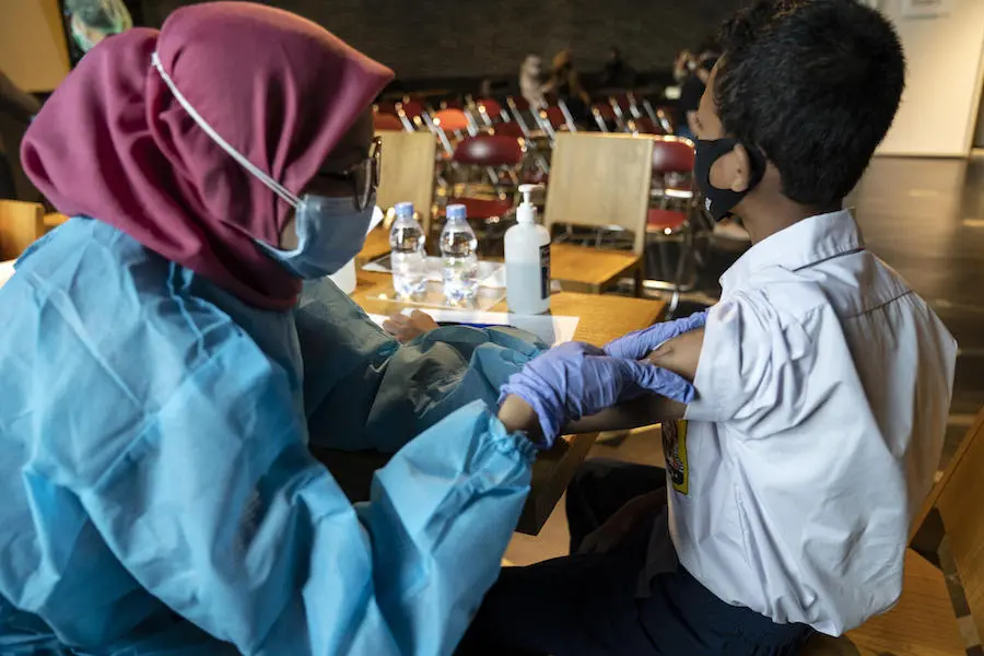 Fazil, 14, receives his second COVID-19 vaccine dose at the Cilandak Town Square Mall in South Jakarta, Indonesia, on August 24, 2021. Fazil, 14, receives his second COVID-19 vaccine dose at the Cilandak Town Square Mall in South Jakarta, Indonesia, on August 24, 2021. 