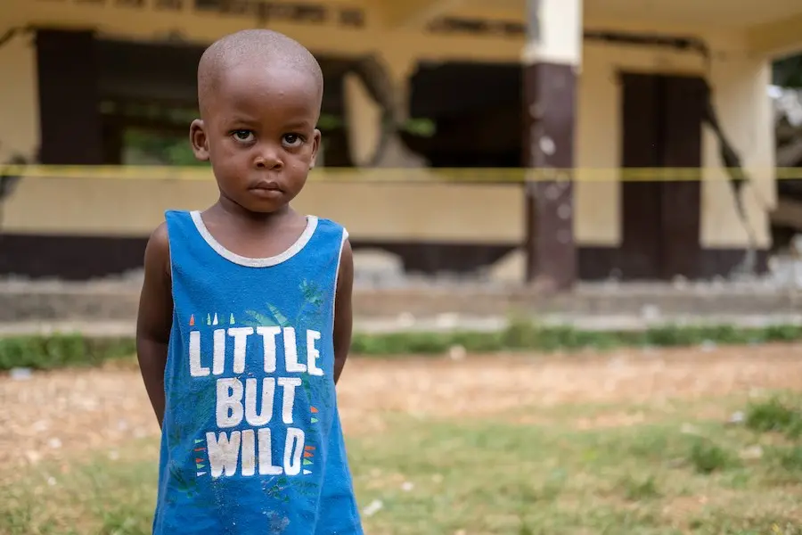 Young Boy Outside of Old Building