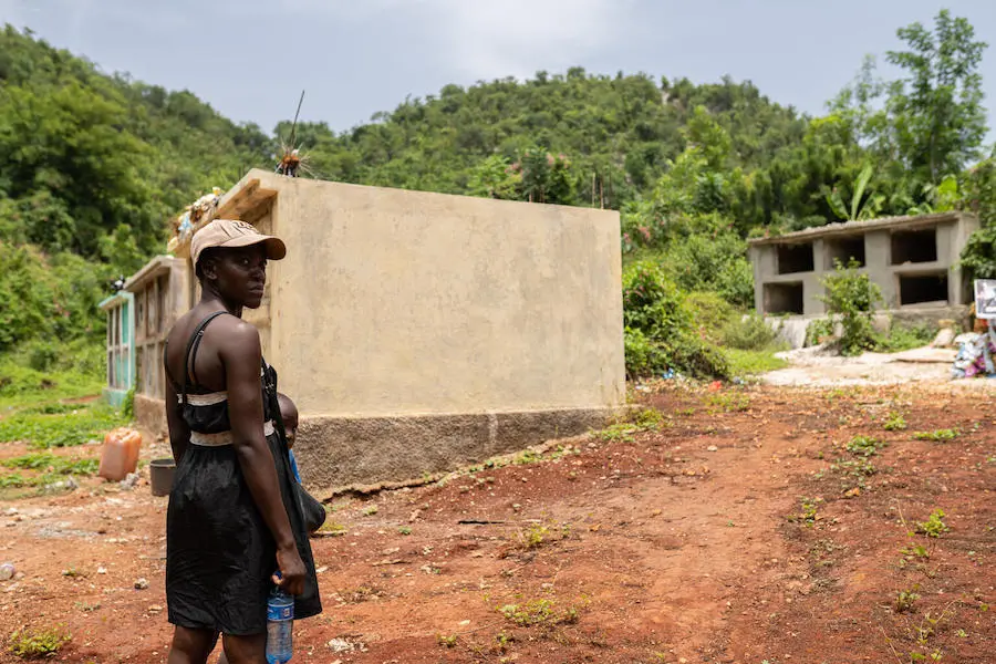 Woman Standing in Front of Concrete Structures