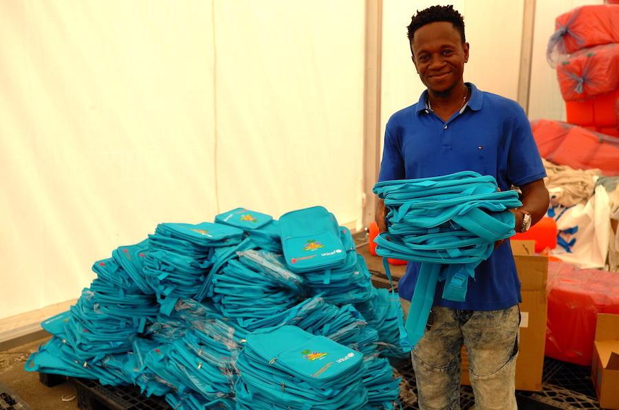 UNICEF staff in Les Cayes, Haiti prepare backpacks filled with school supplies for distribution to students affected by Haiti's August 14, 2021 earthquake. 