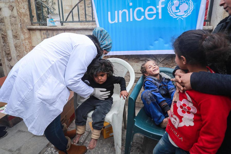 Internally displaced mothers bring their children to the UNICEF-supported health and nutrition mobile clinic for consultation and distribution of medicine at Musab Bin Omair mosque, Tal Hajar, Hasakah city, northeast Syria on January 27, 2022.