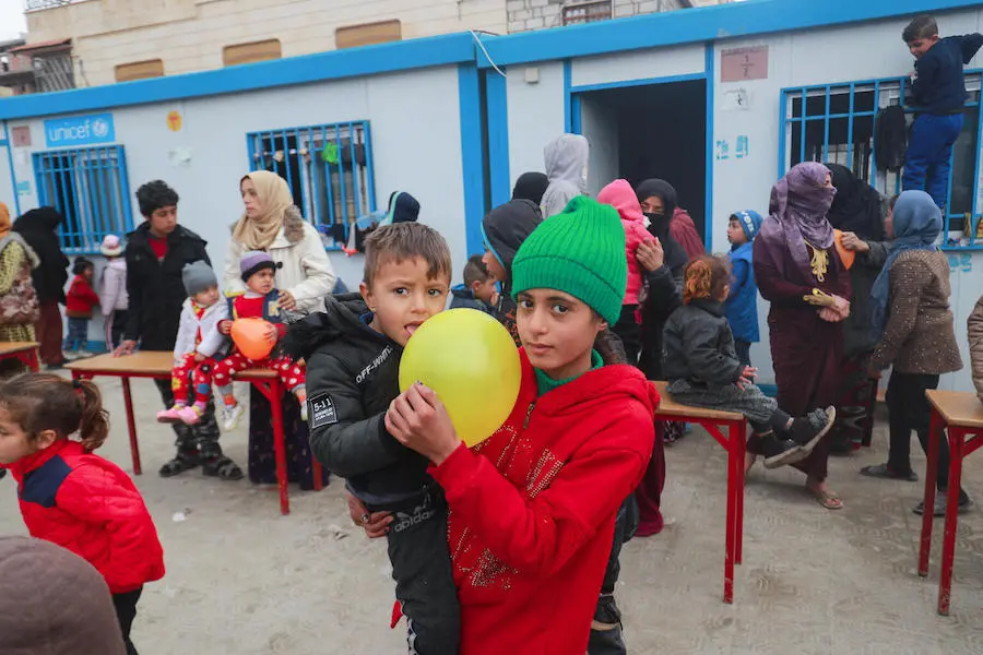 An internally displaced girl holding her brother at Waleed Nofal school in Hasakah city, northeast Syria on January 27, 2022. An internally displaced girl holding her brother at Waleed Nofal school in Hasakah city, northeast Syria on January 27, 2022.
