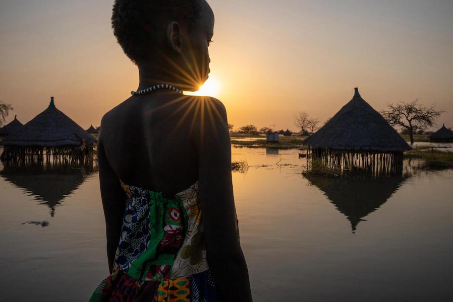 A girl looks out over submerged houses after floodoing in Panyagor, Twic East, Jonglei State, South Sudan. 