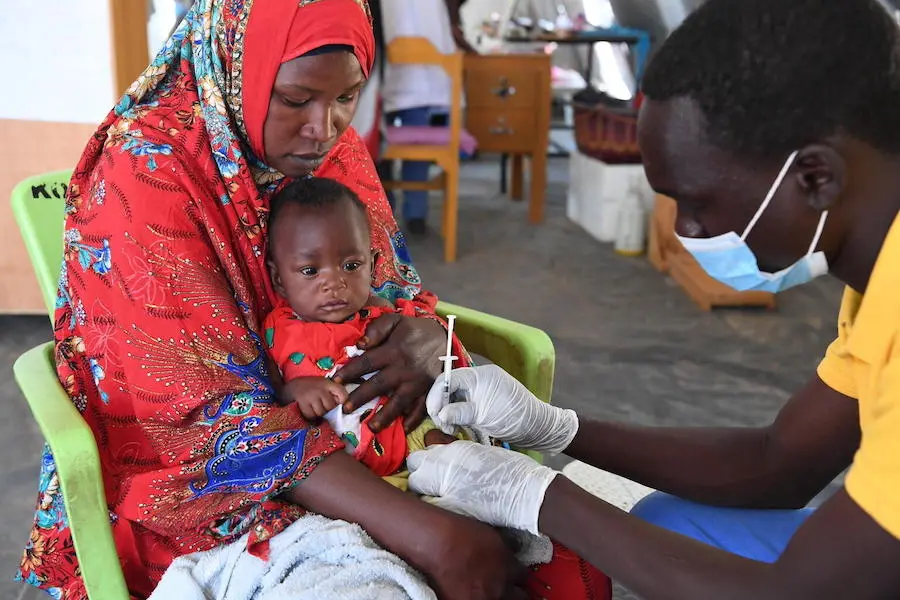 Five-month-old Latifa receives routine immunizations at a UNICEF-supported health center at the Darfur refugee camp in Kouchagui Moura, located near Abeche, east Chad. Five-month-old Latifa receives routine immunizations at a UNICEF-supported health center at the Darfur refugee camp in Kouchagui Moura, located near Abeche, east Chad.