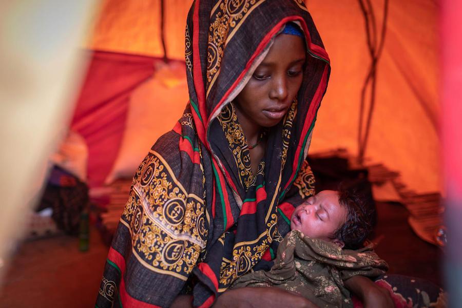 Durran Jaho holds her five-day-old daughter, Fatuma Abdulai ,born in the Burdhubo site for displaced people in Ethiopia.