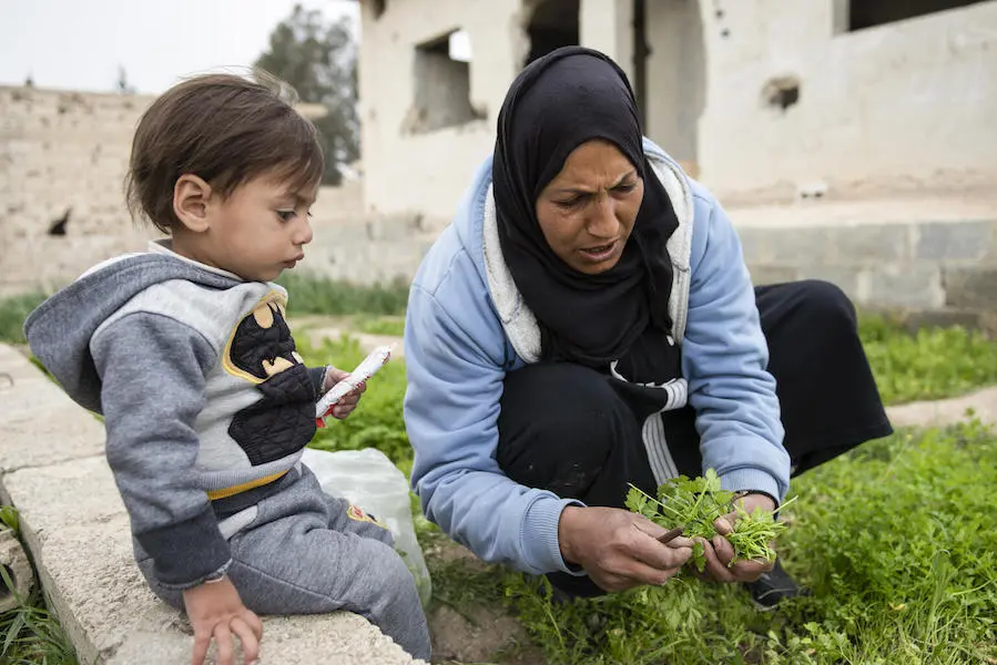 Ishak watches as his grandmother tends the family's vegetable garden in a village in East Ghouta, Rural Damascus, Syria on March 6, 2022. Ishak watches as his grandmother tends the family's vegetable garden in a village in East Ghouta, Rural Damascus, Syria on March 6, 2022.