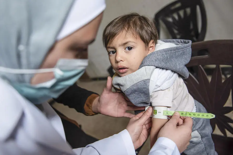Ishak is screened for malnutrition by a UNICEF-supported health worker in East Ghouta, Rural Damascus, Syria. Ishak is screened for malnutrition by a UNICEF-supported health worker in East Ghouta, Rural Damascus, Syria.