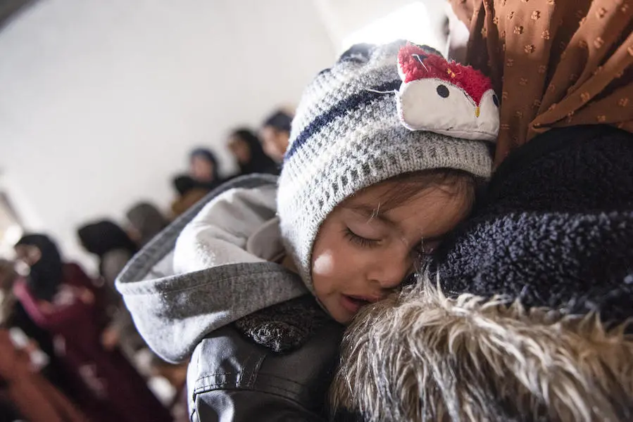 Ishak sleeps on his mother's shoulder while waiting for his checkup from a UNICEF-supported mobile health team in Rural Damascus, Syria on March 8, 2022. Ishak sleeps on his mother's shoulder while waiting for his checkup from a UNICEF-supported mobile health team in Rural Damascus, Syria on March 8, 2022.