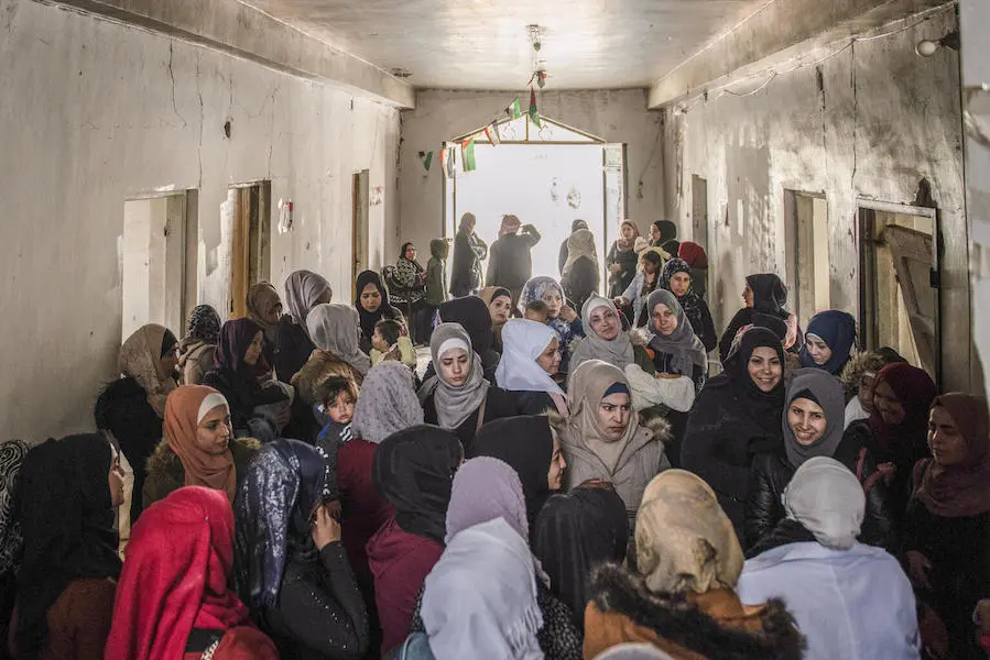 Mothers and children wait to see a UNICEF-supported mobile health team in East Ghouta, Rural Damascus, Syria. Mothers and children wait to see a UNICEF-supported mobile health team in East Ghouta, Rural Damascus, Syria.