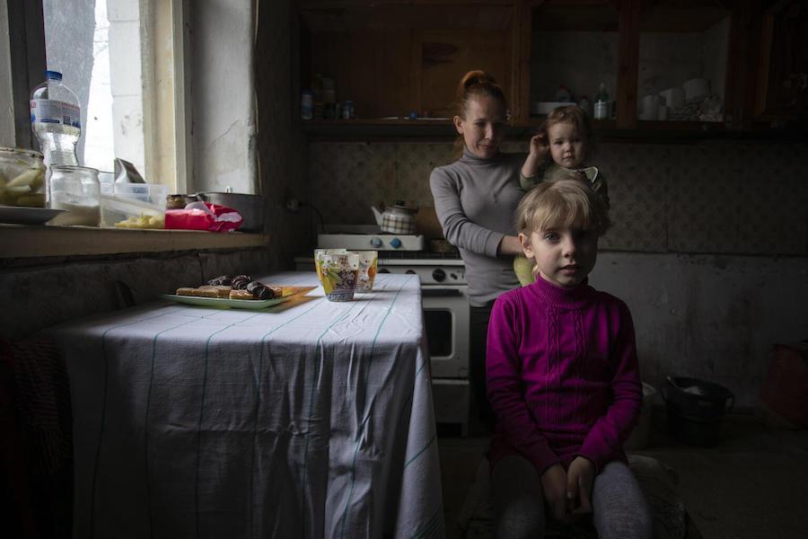 Vika, 8, of Avdiivka, eastern Ukraine, with her mother Hanna and younger sibling at their temporary home in Cherkasy oblast. 