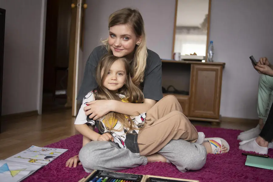 Oleksandra, 16, of Zaporizhzhia, southeastern Ukraine, hugs her sister Katya in their new temporary home in Warsaw, Poland. Oleksandra, 16, of Zaporizhzhia, southeastern Ukraine, hugs her sister Katya in their new temporary home in Warsaw, Poland.