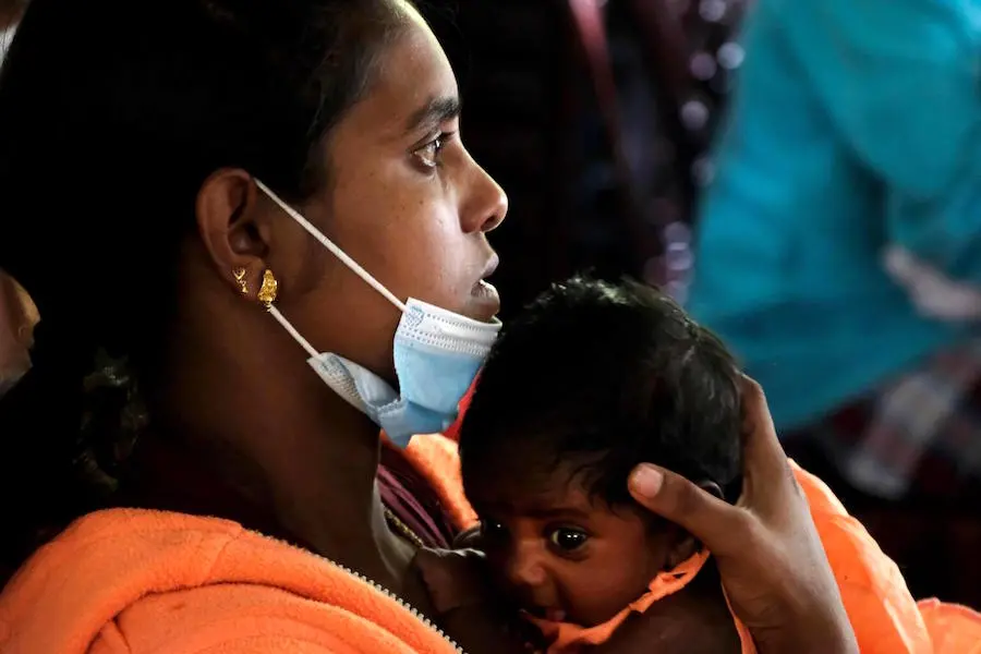 A mother waits with her child inside the UNICEF-supported health clinic in the tea estate area in Hatton, central Sri Lanka on June 3, 2022. A mother waits with her child inside the UNICEF-supported health clinic in the tea estate area in Hatton, central Sri Lanka on June 3, 2022.