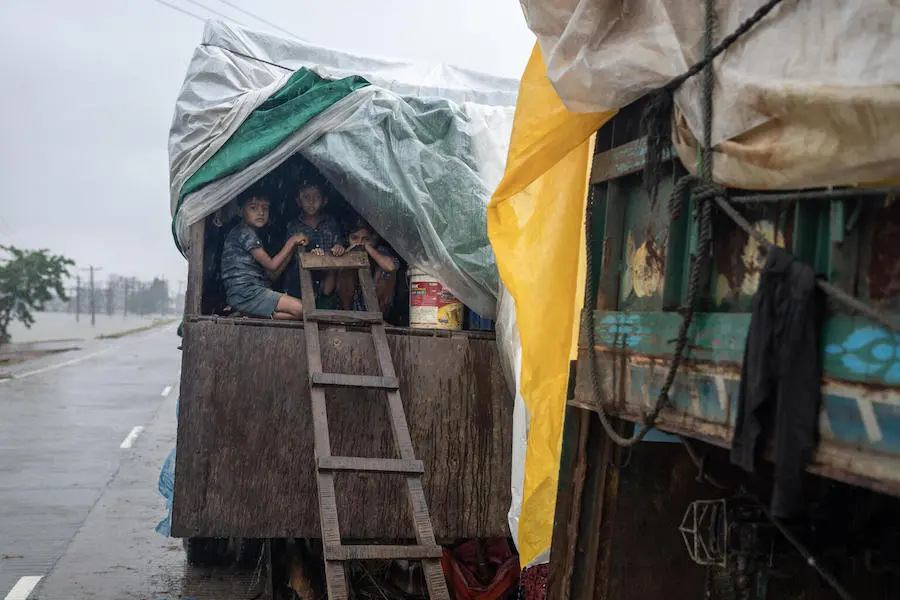 In Sylhet, Bangladesh, Akil and his sisters Fariha and Samia, above, lived in the back of their father's truck for days after furious floodwaters swept away their home and all of their belongings. In Sylhet, Bangladesh, Akil and his sisters Fariha and Samia, above, lived in the back of their father's truck for days after furious floodwaters swept away their home and all of their belongings.