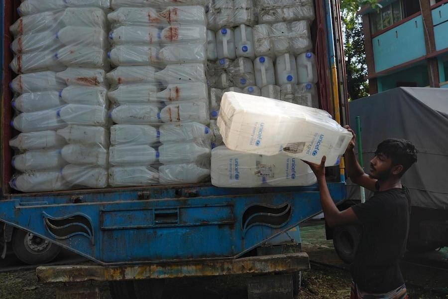 A worker unloads UNICEF emergency supplies for flood-affected families in Sylhet, Bangladesh on June 22, 2022. 