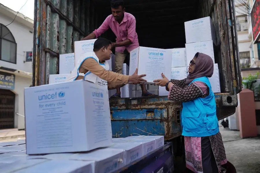 UNICEF staff unload emergency supplies for flood-affected families in Sylhet, Bangladesh on June 22, 2022. UNICEF staff unload emergency supplies for flood-affected families in Sylhet, Bangladesh on June 22, 2022.