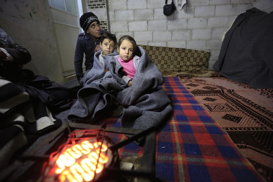 #SyriaCrisis Ashraf, 15, with his brother and sister in the infroal settlement of Al-Khalidia Al-Khamisa in Homs, Syria. UNICEF is targeting 1 million Syrian children with winter supplies during 2015/2016.