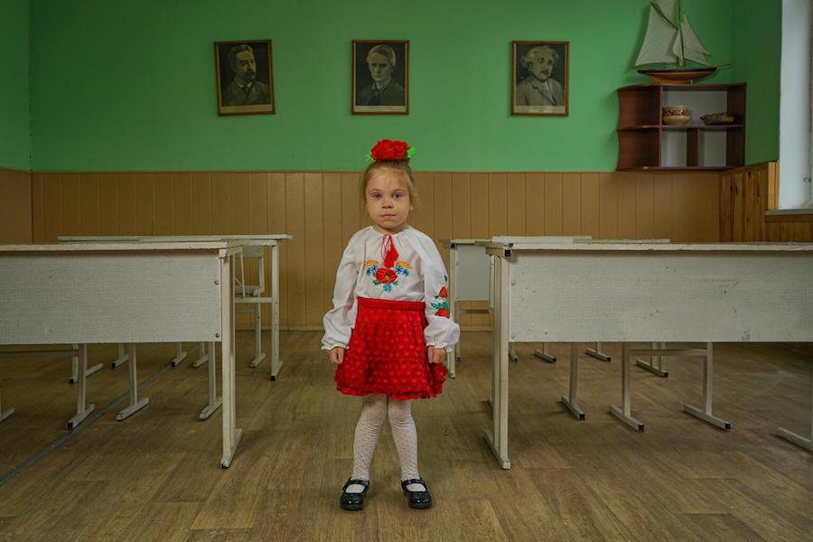 Young Girl Standing in Classroom