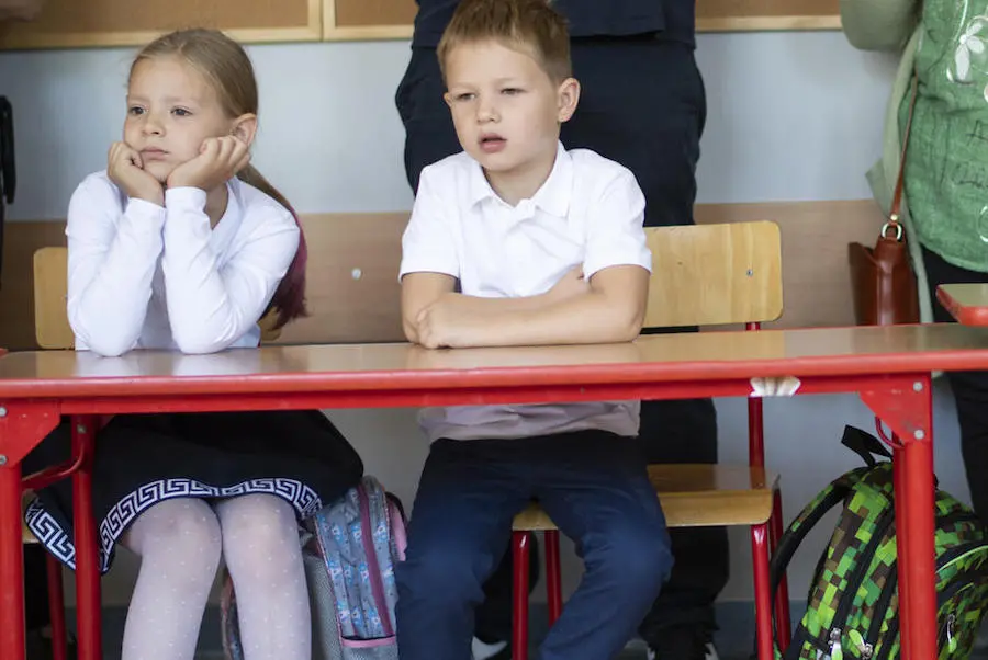 Two Children Sitting at a Desk