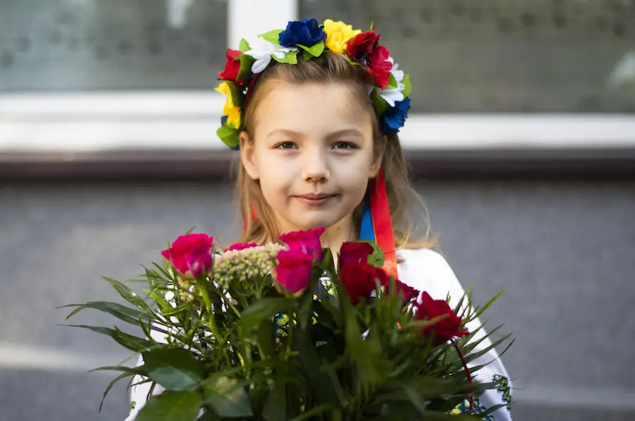 Seven-year-old Emilia, from Irpin, Ukraine, brought two bouquets of flowers to school on the first day in Krakow, Poland, one for her tutor and one for the school principal. Seven-year-old Emilia, from Irpin, Ukraine, brought two bouquets of flowers to school on the first day in Krakow, Poland, one for her tutor and one for the school principal.