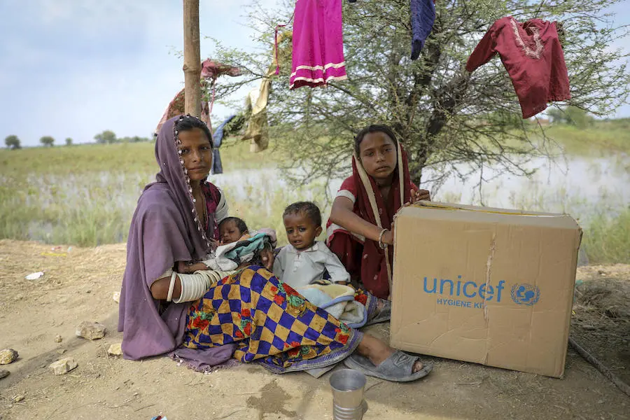 Twenty-year-old Kavita, above far left, mother of Ganesh, 18 months, and 45-day-old Akash, took refuge on a high road on Sept. 2, after flooding swamped the family's home in Mirpur Khas district, Sindh Province. Twenty-year-old Kavita, above far left, mother of Ganesh, 18 months, and 45-day-old Akash, took refuge on a high road on Sept. 2, after flooding swamped the family's home in Mirpur Khas district, Sindh Province.