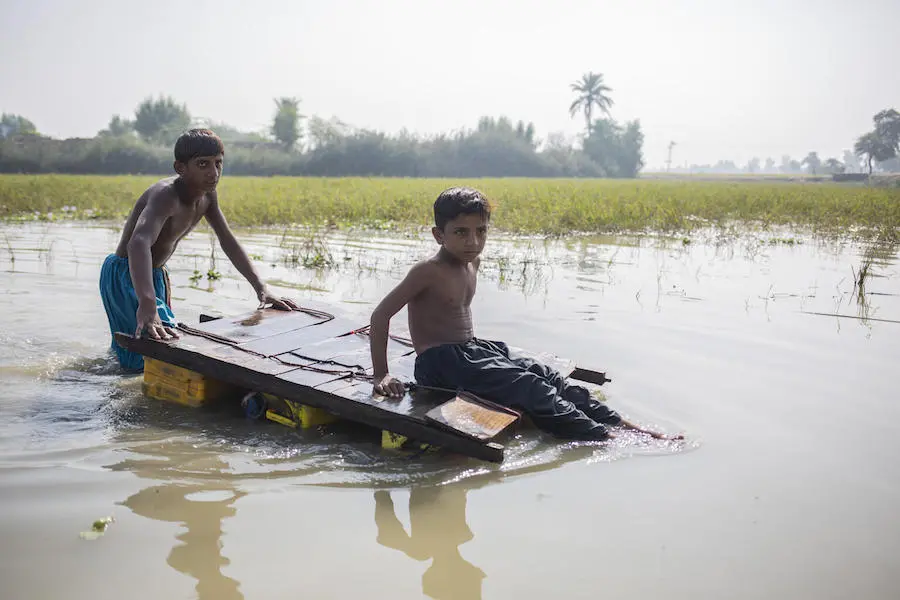 Children in contaminated floodwater in Jacobabad, Sindh Province, Pakistan, on Nov. 3, 2022. Children in contaminated floodwater in Jacobabad, Sindh Province, Pakistan, on Nov. 3, 2022.