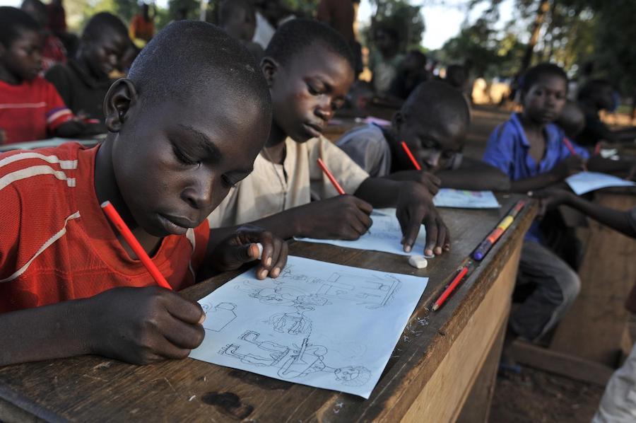 At the Child-Friendly Space in Bossangoa, Central African Republic, children displaced by conflict participate in a drawing session.
