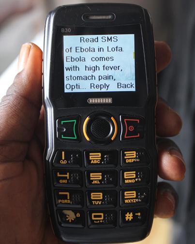 In Liberia, the screen of a mobile phone shows an SMS text message containing information on the symptoms of Ebola virus disease (EVD), in Monrovia, the capital. 