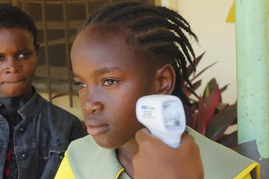 Temperature checks helped ensure a safe return to school for kids in Liberia after the 2014 Ebola outbreak forced a seven-month closure. Temperature checks helped ensure a safe return to the school for kids in Liberia after the 2014 Ebola outbreak forced a seven-month closure.