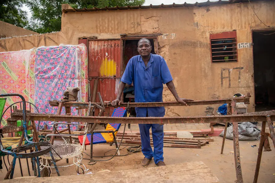 At his welding shop in Niamey, Niger's capital, Henri says he's proud his teenage daughter has stayed in school, attending a UNICEF-sponsored program that combines sport and academics. At his welding shop in Niamey, Niger's capital, Henri says he's proud his teenage daughter has stayed in school, attending a UNICEF-sponsored program that combines sport and academics.