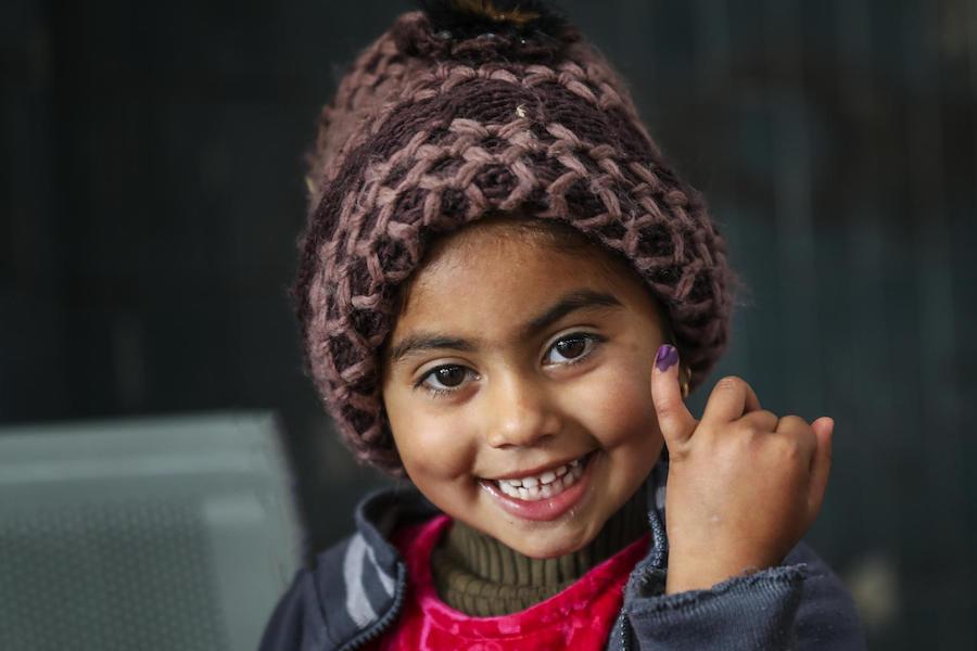 Ajwa, 4, shows the ink mark on her little finger confirming she has received the polio vaccine at Lahore railway station in Lahore Punjab Province, Pakistan in January 2019. 