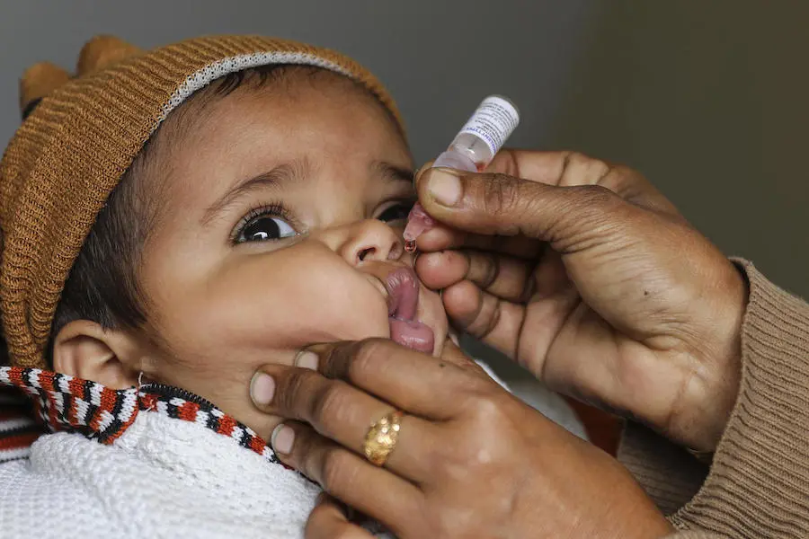 UNICEF-supported health worker Nasreen Aslam vaccinates 1-year-old Ahmad against polio at the door of his house in Dara Chaudhry Kamran, Lahore Punjab Province, Pakistan in January 2019. UNICEF-supported health worker Nasreen Aslam vaccinates 1-year-old Ahmad against polio at the door of his house in Dara Chaudhry Kamran, Lahore Punjab Province, Pakistan in January 2019.