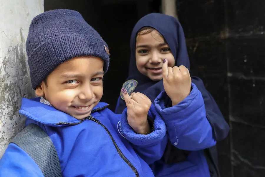 Five-year-olds Abdullah (left) and Mariyam show the ink marks confirming they have received the polio vaccine in the Ponch house area of Lahore Punjab Province, Pakistan in January 2019. Five-year-olds Abdullah (left) and Mariyam show the ink marks confirming they have received the polio vaccine in the Ponch house area of Lahore Punjab Province, Pakistan in January 2019.