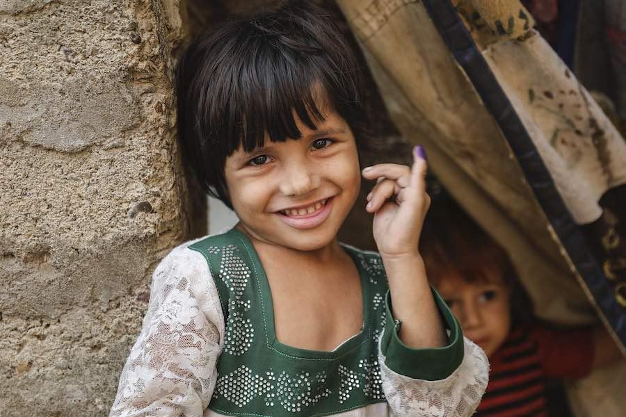 Anila (4) shows ink mark on her little finger, which confirms that she has received polio vaccine during Polio – National Immunisation Day (NID) in Gadab town, Karachi Sindh Province, Pakistan.