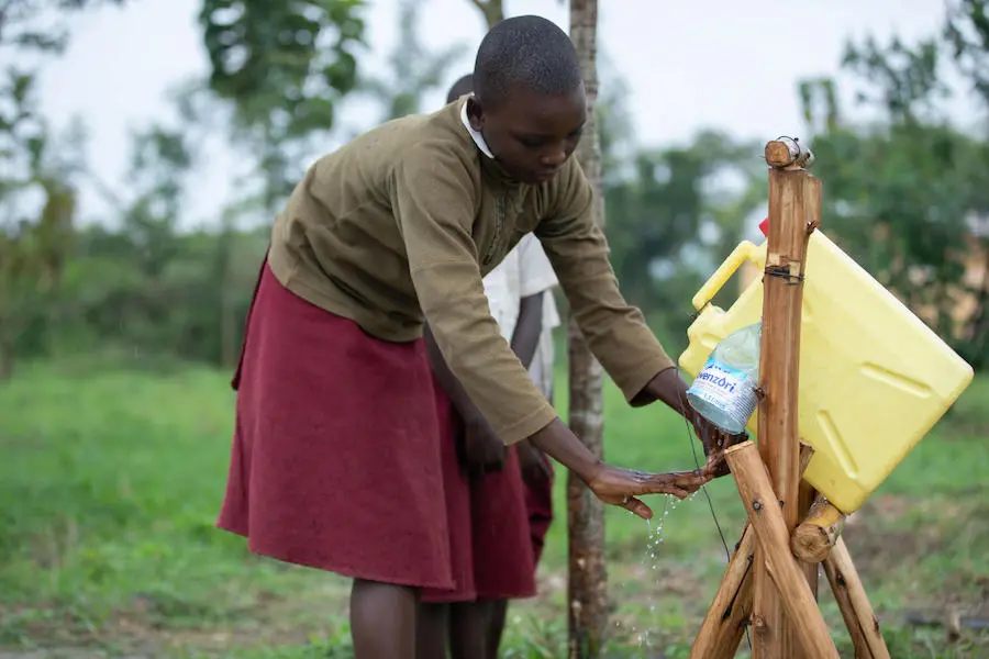 In 2019, a student at the Damasiko Primary School in western Uganda's Kamwenge district uses a tippy tap to wash her hands with soap, part of a UNICEF-led water, sanitation and hygiene improvement program. In 2019, a student at the Damasiko Primary School in western Uganda's Kamwenge district uses a tippy tap to wash her hands with soap, part of a UNICEF-led water, sanitation and hygiene improvement program.