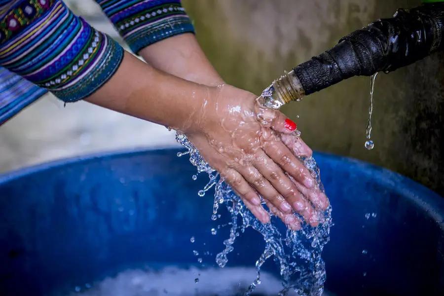 A young girl in Vietnam washes her hands. A young girl in Vietnam washes her hands.