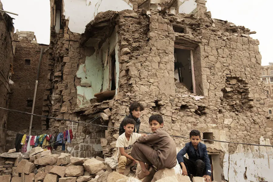 Children sit in front of a house damaged by an air strike inside the old city of Sana'a, Yemen on July 20, 2019. Children sit in front of a house damaged by an air strike inside the old city of Sana'a, Yemen on July 20, 2019.