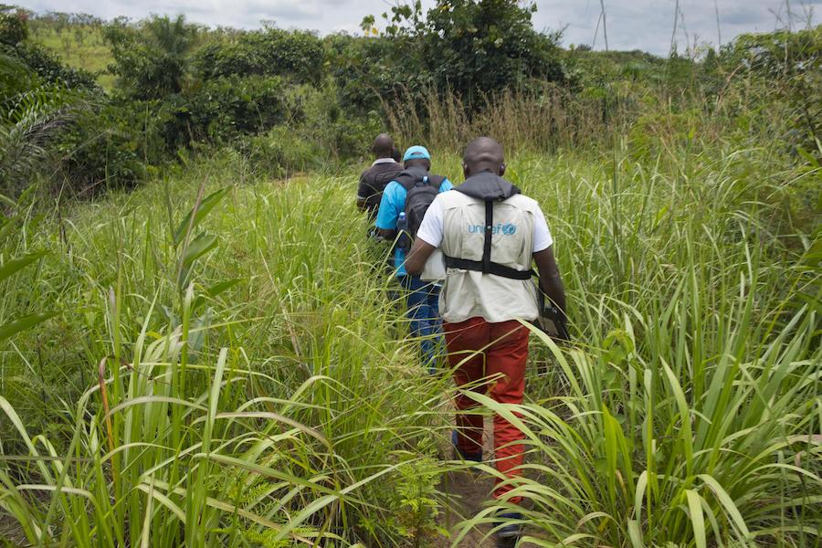 A mobile UNICEF vaccination team walks to a remote village near the Kasai River in Democratic Republic of the Congo on November 5, 2019. The team traveled by boat to reach the location. 