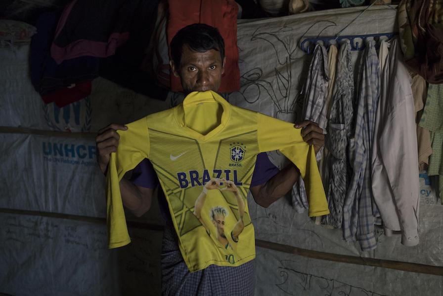 On December 1, 2019, Salim Taallah, 52, holds the football jersey of his son, Korimullah, 12, who went missing six months ago when he went a short distance from the family’s home to play, in Balukhali refugee camp in Cox’s Bazar, Bangladesh.
